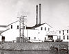 Photograph of the Samuel Elmore Cannery while it was in operation, with a "Bumble Bee" sign hanging above the door.