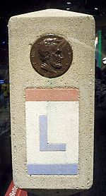 The Lincoln Highway was marked with small concrete obelisks.  Towards the top of the marker was a profile of Abraham Lincoln.  Below the profile, the route is marked with an L painted in red, white, and blue, the colors of the Lincoln Highway.