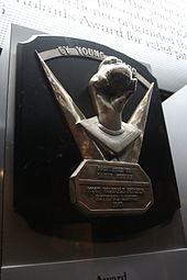A metal hand grips a metal baseball on a black plaque; the inscription reads "Presented to Sandy Koufax; Most Valuable Pitcher, National League, 1953".