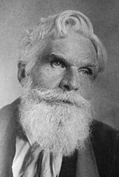 Portrait photo of Havelock Ellis, an older man with white hair and a long beard and piercing eyes