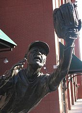A bronze statue in the likeness of Ozzie Smith, depicting him fielding a baseball