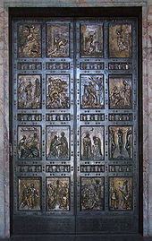 A pair of bronze doors divided into sixteen panels containing reliefs depicting scenes mainly from the life of Jesus and stories that he told.