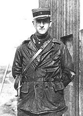 Half portrait of man in military uniform with kepi, outdoors