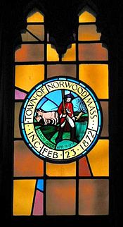 Stained-glass window in Norwood town hall depicting town seal. It was suggested in 2006 that Guild's red coat must surely be historically inaccurate.[9]
