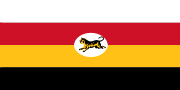 Flag of four stripes along the fly coloured white, red, yellow and black respectively. In the middle is a white oblong circle with a Malayan tiger in it.
