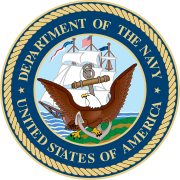Round seal with a bird in front. Words around the edge say Department of the Navy, United States of America