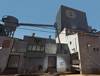 The exterior of a BLU base on the same map, using cooler colors, orthogonal shapes and metal construction