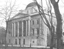 Old black-and-white photo shows a stone building with four columns in front and a domed roof.