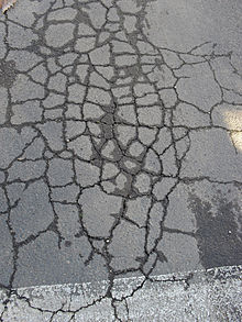 Crocodile cracking in asphalt pavement.