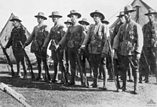 A group of standing men wearing World War I-era military uniforms