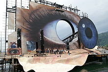 A construction site where a large panel of an eye is being built.