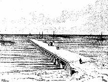 A pier stretching from land out over water