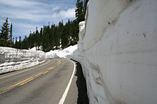 SR 410, east of Tipsoo Lake, approches Chinook Pass, which serves as the border between Pierce and Yakima counties and between the Mount Rainier National Park and Wenatchee National Forest, in June when snow levels are still high and snow plows still are in use.