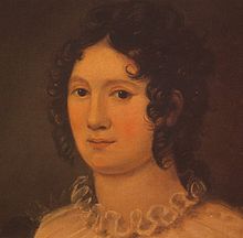 Portrait of a woman showing her neck and head. She has brown hair in ringlet curls and we can see the ruffle from the top of her dress. The painting is done in a palette of oranges and browns.
