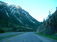 A highway about to curve to the right while descending down a canyon
