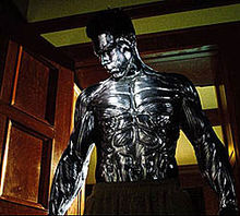 Daniel Cudmore as Colossus in a scene where he is entering a reoom in pajama bottoms and in his armored form.