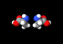 Animation of two mirror image molecules rotating around a central axis.