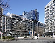 DIN headquarters is a modern 7-story office building with their logo on the front
