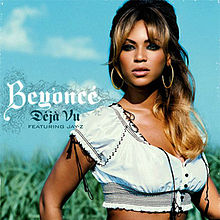 The picture of a brunette woman. She wears soft make-up and earrings, and a short white shirt. Next to her, there are some words: the word "Beyoncé" is written in white bolded letters; "Déjà Vu" in midnight tone words; and "featuring Jay-Z" in black capital letters. Behind her the sky is appreciated.