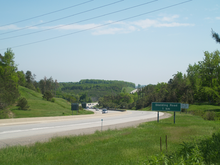 "A photo of a four-lane divided highway on a sunny day."