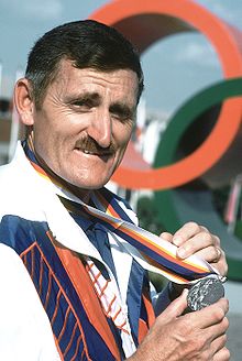 Erich Buljung shows off a silver medal he won in the 10m air pistol competition at the 1988 Summer Olympics.