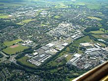 Aerial image of central and southern Glenrothes (view looking southwest) showing the town centre shopping mall, Queensway retail park and the industrial and housing estates surrounding the centre