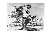 A dismembered and mutilated corpse is impaled on the branches of a tree.