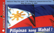 A card with the words "single journey" in a red rectangle going down the left side taking about 10% of it and the rest showing a drawing of a wavy flag containing a white triangle with stylized sun and stars on a field of blue and red. Above the flag is a reference to National Flag Day and the 111th Philippine Independence Day and corresponding dates. Underneath are the words "Pilipinas kong Mahal!" (My Beloved Philippines).