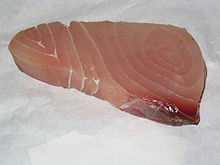 Approximately triangular piece of pink-to-red fish