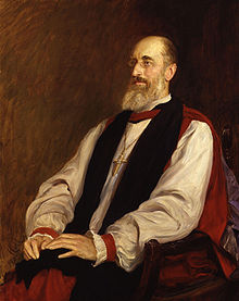 A painting of a gaunt and balding man, with greying hair and a long grey beard, sitting in a wooden chair. He wears a puffy white shirt, a black stole, and a long red robe; he also wears small round glasses, and around his neck is a large gold cross.