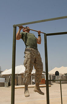 Picture of a US Marine performing a pull-up.