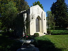 White stone mausoleum with iron doors and "Mars" engraved near the top