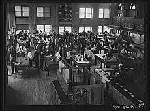 several dozen men inside the grain exchange with two stories of windows