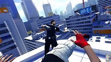 A uniformed character, standing on a rooftop, falls back after being kicked. Two arms and a leg belonging to the player's character are visible.