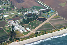 airstrip and buildings on coast in farm fields