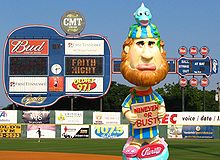 A bobblehead depicting an unhappy bearded man wearing a yellow and blue robe and hat holding a sign reading, "Nineveh or bust"