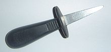 Photo of a rubber-handled steel oyster knife.