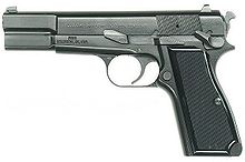 pistol facing left showing safety catch and slide release