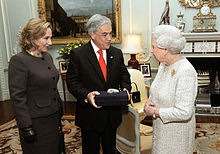 Color image of Chilean President Piñera and the First Lady present a souvenir gift rock from the San Jose Mine to Queen Elizabeth II on 18 October 2010 during a state visit to the UK