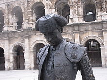 Statue of Nimeño in front of the Roman amphitheatre in Nîmes, France