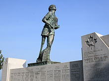 Statue of a runner with an artificial leg looking skyward.