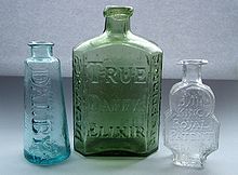 Three empty bottle medicine bottles, the centre on embossed with the words 'Dicey and Co. True Daffy's Elixir