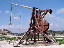 A tall wooden structure with a throwing arm counter-balanced by a large weight