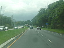A four-lane divided highway in a wooded area