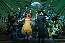 Kristin Chenoweth and Idina Menzel perform "One Short Day" with the rest of Wicked's original cast