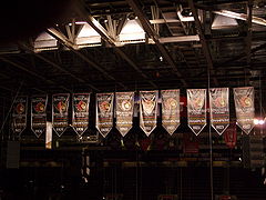Eleven black, red and white banners, each with an Ottawa Senators logo, the year of a Senators championship win.
