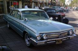 1962 Buick Electra 225 sedan. Wheels and mirrors are not factory, but four ventiports on side of fender were unique to Electra.