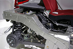 The engine of the i as seen in cutaway, behind the rear seats and under the floor of the rear hatch storage area.
