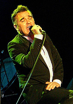 A man singing on stage.