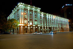 Large square building, lit up at night